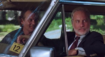 Movie still from “What About Bob?” (1991), directed by Frank Oz – Two men sitting in the back seat of a car; Close Up shot, Low angle