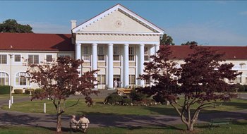 Movie still from “What About Bob?” (1991), directed by Frank Oz – A large white building sitting in the middle of a park; Extreme Wide shot, Low angle