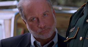 Movie still from “What About Bob?” (1991), directed by Frank Oz – An older man wearing a suit and tie; Close Up shot, Over the shoulder angle