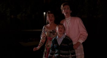 Movie still from “What About Bob?” (1991), directed by Frank Oz – A group of three people standing next to each other; Medium shot, Low angle