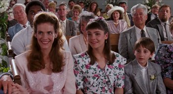 Movie still from “What About Bob?” (1991), directed by Frank Oz – A group of people sitting in front of each other; Medium shot, High angle