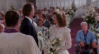 Movie still from “What About Bob?” (1991), directed by Frank Oz – A man and a woman are standing in front of a crowd; Medium shot, Over the shoulder angle