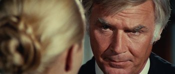 Movie still from “What Have You Done to Solange?” (1972), directed by Massimo Dallamano – An older man looking into a mirror while a younger man looks on; Close Up shot, Over the shoulder angle