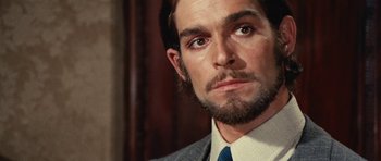 Movie still from “What Have You Done to Solange?” (1972), directed by Massimo Dallamano – A person wearing a suit and tie; Close Up shot, Low angle