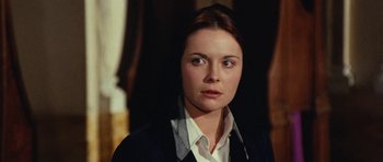 Movie still from “What Have You Done to Solange?” (1972), directed by Massimo Dallamano – A young woman in business attire is looking at the camera; Close Up shot, Over the shoulder angle