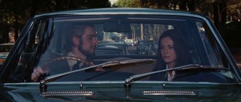 Movie still from “What Have You Done to Solange?” (1972), directed by Massimo Dallamano – A man and a woman sitting in the back seat of a car; Medium shot, High angle