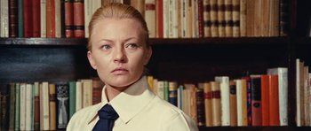 Movie still from “What Have You Done to Solange?” (1972), directed by Massimo Dallamano – A woman standing in front of a book shelf in a library; Close Up shot, Low angle