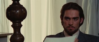 Movie still from “What Have You Done to Solange?” (1972), directed by Massimo Dallamano – A person sitting in front of a laptop; Close Up shot, Over the shoulder angle