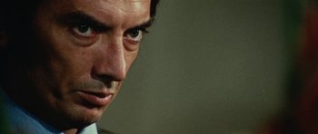 Movie still from “What Have You Done to Solange?” (1972), directed by Massimo Dallamano – A man's face in a room; Extreme Close Up shot, Low angle