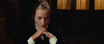 Movie still from “What Have You Done to Solange?” (1972), directed by Massimo Dallamano – A woman in a black jacket and a white shirt is holding her hands to her face; Close Up shot, High angle