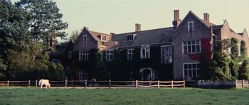 Movie still from “What Have You Done to Solange?” (1972), directed by Massimo Dallamano – An old house with a fence in front of it; Extreme Wide shot, Low angle