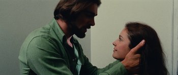 Movie still from “What Have You Done to Solange?” (1972), directed by Massimo Dallamano – A man and a woman touching each other's hair; Close Up shot, Low angle