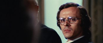 Movie still from “What Have You Done to Solange?” (1972), directed by Massimo Dallamano – A person wearing glasses; Close Up shot, Low angle