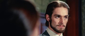 Movie still from “What Have You Done to Solange?” (1972), directed by Massimo Dallamano – A person wearing a suit and beard; Close Up shot, Over the shoulder angle