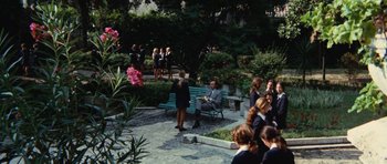 Movie still from “What Have You Done to Solange?” (1972), directed by Massimo Dallamano – A group of people standing around a park bench; Extreme Wide shot, High angle