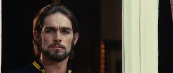 Movie still from “What Have You Done to Solange?” (1972), directed by Massimo Dallamano – A person with long hair and a beard; Close Up shot, Over the shoulder angle