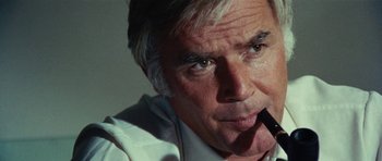 Movie still from “What Have You Done to Solange?” (1972), directed by Massimo Dallamano – An older man is holding a pen in his mouth; Close Up shot, Low angle