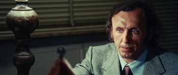 Movie still from “What Have You Done to Solange?” (1972), directed by Massimo Dallamano – A person wearing a suit and tie; Close Up shot, Over the shoulder angle