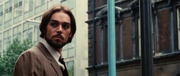 Movie still from “What Have You Done to Solange?” (1972), directed by Massimo Dallamano – A person wearing a suit and tie; Close Up shot, Low angle