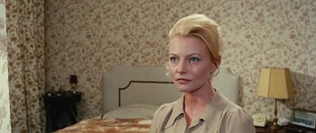 Movie still from “What Have You Done to Solange?” (1972), directed by Massimo Dallamano – A woman with blonde hair and blue eyes in front of a bed; Close Up shot, Over the shoulder angle