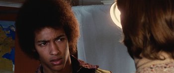 Movie still from “What Have You Done to Solange?” (1972), directed by Massimo Dallamano – A young man with a curly hair style is looking at the camera; Close Up shot, Low angle