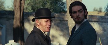 Movie still from “What Have You Done to Solange?” (1972), directed by Massimo Dallamano – A man wearing a black hat and a black jacket; Close Up shot, Low angle