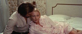 Movie still from “What Have You Done to Solange?” (1972), directed by Massimo Dallamano – A woman laying on a bed with a man next to her; Medium shot, High angle