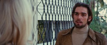 Movie still from “What Have You Done to Solange?” (1972), directed by Massimo Dallamano – A man standing in front of an iron fence; Close Up shot, Over the shoulder angle