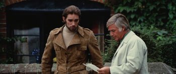 Movie still from “What Have You Done to Solange?” (1972), directed by Massimo Dallamano – A man in a brown jacket standing next to another man in a lab coat; Medium shot, Over the shoulder angle