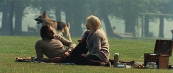 Movie still from “What Have You Done to Solange?” (1972), directed by Massimo Dallamano – A man and a woman sitting on the grass in a park; Wide shot, High angle