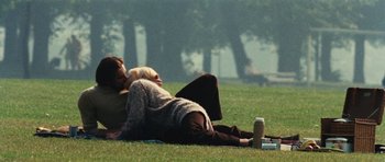 Movie still from “What Have You Done to Solange?” (1972), directed by Massimo Dallamano – Two people laying in the grass on a blanket; Wide shot, High angle