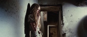 Movie still from “What Have You Done to Solange?” (1972), directed by Massimo Dallamano – A woman in a dress standing next to a wall; Medium shot, Low angle