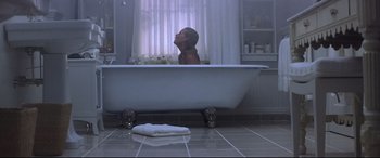 Movie still from “What Lies Beneath” (2000), directed by Robert Zemeckis – A woman sitting in a bathtub in a bathroom; Wide shot, Overhead angle