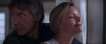 Movie still from “What Lies Beneath” (2000), directed by Robert Zemeckis – A man and a woman sitting next to each other; Close Up shot, Low angle