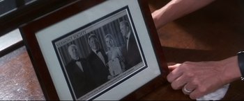 Movie still from “What Lies Beneath” (2000), directed by Robert Zemeckis – A person holding up a picture of a family; Extreme Close Up shot, Overhead angle