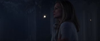 Movie still from “What Lies Beneath” (2000), directed by Robert Zemeckis – A woman standing in the dark looking at the moon; Medium shot, Over the shoulder angle