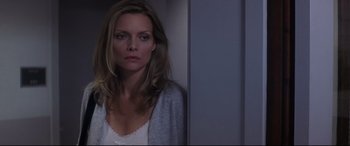 Movie still from “What Lies Beneath” (2000), directed by Robert Zemeckis – A woman standing in front of a wall with her eyes closed; Close Up shot, Over the shoulder angle