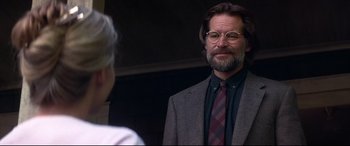 Movie still from “What Lies Beneath” (2000), directed by Robert Zemeckis – A man in a suit and tie standing next to a woman; Close Up shot, Over the shoulder angle