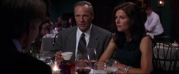 Movie still from “What Lies Beneath” (2000), directed by Robert Zemeckis – A man and a woman sitting at a dinner table; Medium shot, Over the shoulder angle