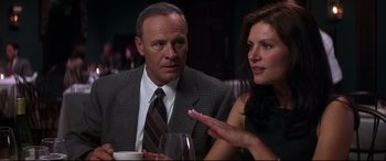 Movie still from “What Lies Beneath” (2000), directed by Robert Zemeckis – A man and a woman sitting next to each other at a table; Close Up shot, Over the shoulder angle