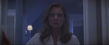 Movie still from “What Lies Beneath” (2000), directed by Robert Zemeckis – A woman in a white shirt is looking at the camera; Close Up shot, Low angle