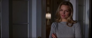 Movie still from “What Lies Beneath” (2000), directed by Robert Zemeckis – A woman standing in front of a window in a room; Close Up shot, Over the shoulder angle