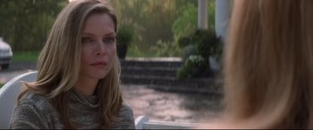 Movie still from “What Lies Beneath” (2000), directed by Robert Zemeckis – A beautiful woman sitting in front of a fountain; Close Up shot, Over the shoulder angle