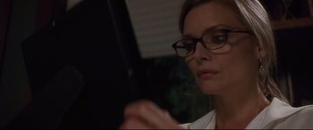 Movie still from “What Lies Beneath” (2000), directed by Robert Zemeckis – A person wearing glasses smoking a cigarette; Close Up shot, Low angle