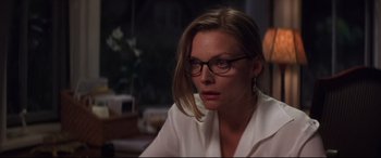 Movie still from “What Lies Beneath” (2000), directed by Robert Zemeckis – A person wearing glasses and a white shirt; Close Up shot, Over the shoulder angle