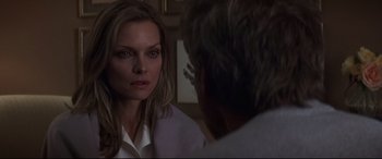 Movie still from “What Lies Beneath” (2000), directed by Robert Zemeckis – A woman looking into a mirror while standing next to a man; Close Up shot, Over the shoulder angle
