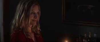 Movie still from “What Lies Beneath” (2000), directed by Robert Zemeckis – A beautiful blonde woman in a red dress; Close Up shot, Over the shoulder angle