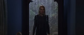 Movie still from “What Lies Beneath” (2000), directed by Robert Zemeckis – A woman standing in front of a window in the rain; Medium shot, Over the shoulder angle