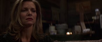 Movie still from “What Lies Beneath” (2000), directed by Robert Zemeckis – A person sitting in front of candles; Close Up shot, Over the shoulder angle