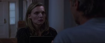 Movie still from “What Lies Beneath” (2000), directed by Robert Zemeckis – A woman looking at a man in the mirror; Close Up shot, Over the shoulder angle